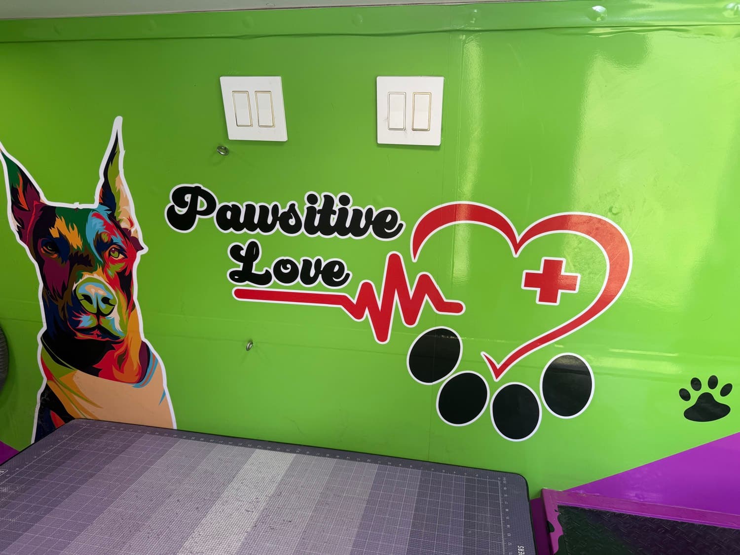 Pawsitive Love Dog groomer with colorful dog art